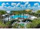 Expansive community pool area with lounge chairs, cabanas, and lush landscaping at 15707 Sacile Ln, Bradenton, FL 34211