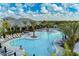 Expansive community pool area with many lounge chairs, palm trees and a well-maintained landscape at 15707 Sacile Ln, Bradenton, FL 34211