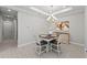 Dining room features a modern chandelier, tile floors, neutral decor, and view of living area at 15707 Sacile Ln, Bradenton, FL 34211