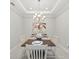 Elegant dining room with a classic chandelier and seating for four at 15707 Sacile Ln, Bradenton, FL 34211