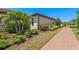 Landscaped view of property with manicured plantings and brick walkway at 15707 Sacile Ln, Bradenton, FL 34211