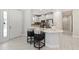 Bright, modern kitchen with white cabinetry, bar seating, and stainless steel appliances at 15707 Sacile Ln, Bradenton, FL 34211