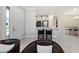 Open-concept kitchen features white cabinets, an island with seating, stainless appliances, and tile flooring at 15707 Sacile Ln, Bradenton, FL 34211