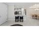 Open floor plan shows bar seating, kitchen, and dining area with lots of natural light at 15707 Sacile Ln, Bradenton, FL 34211