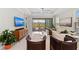 Bright living room with high ceilings, ceiling fan, and sliding glass doors to the lanai and pool at 15707 Sacile Ln, Bradenton, FL 34211