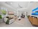 Bright living room with neutral tones, stylish furnishings, and a ceiling fan at 15707 Sacile Ln, Bradenton, FL 34211