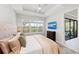 Bedroom features a large window, tray ceiling with fan, dresser, and tv at 15707 Sacile Ln, Bradenton, FL 34211