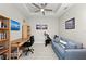 Inviting office space with a desk, bookshelf, comfortable sofa, and exercise equipment, perfect for work and fitness at 15707 Sacile Ln, Bradenton, FL 34211