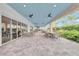 A covered outdoor patio with tables and chairs, perfect for dining and relaxation at 15707 Sacile Ln, Bradenton, FL 34211