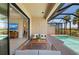 Comfortable patio area offering seamless transition to the interior and lovely views of the screened-in pool at 15707 Sacile Ln, Bradenton, FL 34211