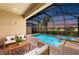 Relaxing screened-in pool and spa with a beautiful view of the evening sky and surrounding community at 15707 Sacile Ln, Bradenton, FL 34211