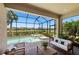 Serene screened-in pool and spa area, complemented by patio seating and a scenic view of the neighborhood at 15707 Sacile Ln, Bradenton, FL 34211