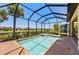Bright, screened-in pool and spa offering clear views of the backyard, lake, and community beyond at 15707 Sacile Ln, Bradenton, FL 34211
