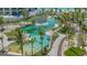 Aerial view of a luxury resort featuring pools, palm trees, and lush landscaping at 1591 Gulf Of Mexico Dr # 511, Longboat Key, FL 34228