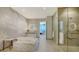 Bright bathroom with sleek vanity, modern tub, and walk-in shower with ocean view access at 1591 Gulf Of Mexico Dr # 511, Longboat Key, FL 34228