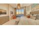 Luxurious bedroom with sunset views from the large window, complemented by modern decor and a cozy seating area at 1591 Gulf Of Mexico Dr # 511, Longboat Key, FL 34228