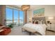 Bright bedroom features a king bed, large window with a view, and a decorative light fixture at 1591 Gulf Of Mexico Dr # 511, Longboat Key, FL 34228