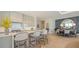 Modern kitchen with an island with bar seating, stainless appliances and open to dining area at 1591 Gulf Of Mexico Dr # 511, Longboat Key, FL 34228