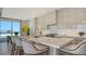 Modern kitchen with large island, marble countertops, stainless appliances, and an incredible view at 1591 Gulf Of Mexico Dr # 511, Longboat Key, FL 34228