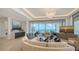 Bright living room features modern decor, ocean views, and a stylish chandelier at 1591 Gulf Of Mexico Dr # 511, Longboat Key, FL 34228