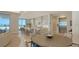 Open-concept living space with dining table, kitchen, and elevator at 1591 Gulf Of Mexico Dr # 511, Longboat Key, FL 34228