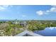Aerial view of the surrounding neighborhood showing the lush landscape and water views at 19 Whispering Sands Dr # 805, Sarasota, FL 34242