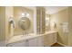 Bright bathroom featuring double sinks, vanity with storage, mosaic tile accents, and decorative mirrors at 19 Whispering Sands Dr # 805, Sarasota, FL 34242