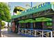 Exterior view of a lively beach bar with outdoor seating and surfboards adorning the walls at 19 Whispering Sands Dr # 805, Sarasota, FL 34242