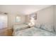 Bedroom showcasing twin beds, tile flooring, neutral wall paint, and beach-themed wall decor at 19 Whispering Sands Dr # 805, Sarasota, FL 34242