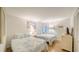 Bright bedroom featuring twin beds with patterned linens, a window with shutters, and tile flooring at 19 Whispering Sands Dr # 805, Sarasota, FL 34242