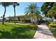 Beautiful landscaping surrounds the clubhouse with flowering bushes and lush green grass at 19 Whispering Sands Dr # 805, Sarasota, FL 34242
