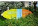 Siesta Key Village colorful sign surrounded by shrubbery at 19 Whispering Sands Dr # 805, Sarasota, FL 34242