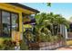 Exterior view of a raw bar with a patio and lush tropical plants at 19 Whispering Sands Dr # 805, Sarasota, FL 34242