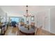 Open concept dining room with chandelier, tile flooring, and ocean views at 19 Whispering Sands Dr # 805, Sarasota, FL 34242
