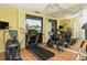 Well-equipped fitness center with modern cardio machines and a mirrored wall for a full body view at 19 Whispering Sands Dr # 805, Sarasota, FL 34242