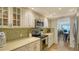 Well-lit kitchen with stainless steel appliances, tiled backsplash, and neutral countertops at 19 Whispering Sands Dr # 805, Sarasota, FL 34242
