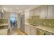 Modern kitchen with stainless steel appliances, neutral countertops, and open to dining area with ocean views at 19 Whispering Sands Dr # 805, Sarasota, FL 34242