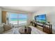 Living room featuring a large sliding door that floods the room with natural light and ocean views at 19 Whispering Sands Dr # 805, Sarasota, FL 34242
