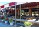 Outdoor restaurant seating with tables and wooden pergola at 19 Whispering Sands Dr # 805, Sarasota, FL 34242