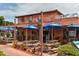 Exterior of a vibrant restaurant with colorful umbrellas and outdoor seating at 19 Whispering Sands Dr # 805, Sarasota, FL 34242