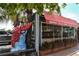A seafood restaurant with outdoor dining and a large lobster statue at 19 Whispering Sands Dr # 805, Sarasota, FL 34242