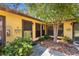 Charming exterior view highlighting the home's architecture, including unit entrances and landscaping, and a small tree at 2006 7Th W Ave # B, Bradenton, FL 34205