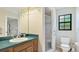 Bathroom featuring a sink with wooden cabinets and a walk-in shower at 2061 Misty Sunrise Trl, Sarasota, FL 34240