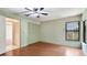 Bright bedroom featuring hardwood floors and built-in closet at 2061 Misty Sunrise Trl, Sarasota, FL 34240