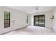 Minimalist bedroom with a view of the pool, natural light, and neutral carpeting at 2061 Misty Sunrise Trl, Sarasota, FL 34240