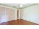 Bedroom with hardwood floors and a closet, and an entrance to another room at 2061 Misty Sunrise Trl, Sarasota, FL 34240