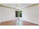 Charming bedroom featuring wood floors and windows with views of greenery at 2061 Misty Sunrise Trl, Sarasota, FL 34240
