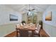 Light and airy dining room with views of greenery, hardwood floors, and large dining table at 2061 Misty Sunrise Trl, Sarasota, FL 34240