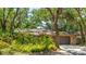 Inviting home with attached garage and front yard featuring an array of beautiful, well-maintained plantings at 2061 Misty Sunrise Trl, Sarasota, FL 34240