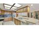 Kitchen with stainless appliances, granite countertops, breakfast bar, and view of double doors to patio at 2061 Misty Sunrise Trl, Sarasota, FL 34240